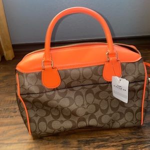 NWTs Neon Orange coach satchel with shoulder strap that clips .